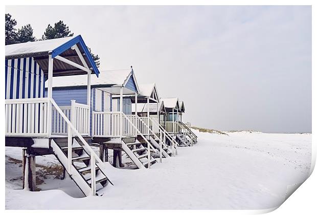 Beach huts covered in snow at low tide. Wells-next Print by Liam Grant