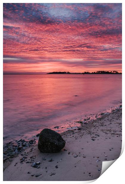 Pink dawn sky reflected in the surface of the sea. Print by Liam Grant