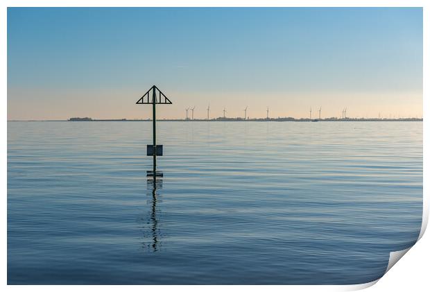 Seashore marker post and wind turbines Print by Gary Eason