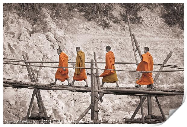 Buddhist monks across a bamboo bridge Print by stefano baldini