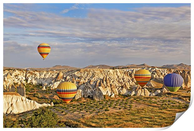 Balloons drifting through Cappadocia gorge Print by Arfabita  