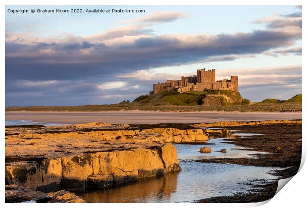 Bamburgh Castle from Harkness Rocks sunset Print by Graham Moore
