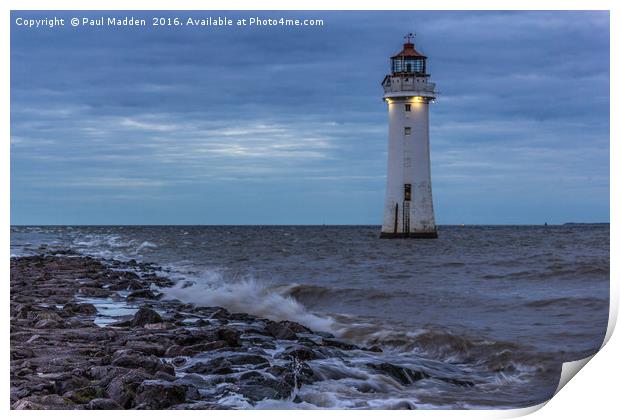 Lighthouse on the rocks Print by Paul Madden